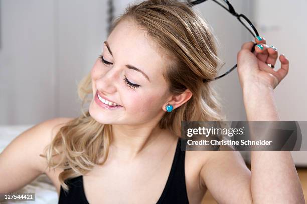 woman taking off her glasses - taking off glasses stock pictures, royalty-free photos & images