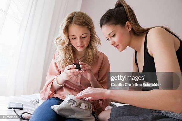 teenage girls going through makeup - make up bag stock pictures, royalty-free photos & images