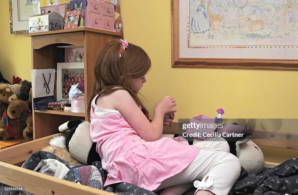 Girl playing with toys in bedroom