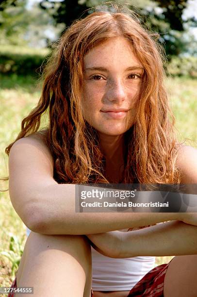 girl sitting in grass in backyard - one teenage girl only stock pictures, royalty-free photos & images