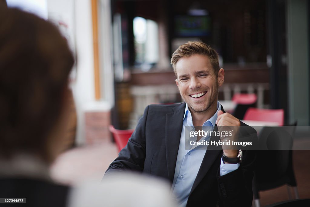 Businessman laughing at lunch