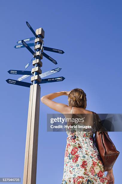 woman reading directions at crossroads - hermanus stock pictures, royalty-free photos & images