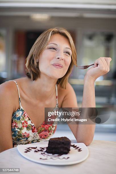 woman eating dessert at cafe - chocolate cake stock pictures, royalty-free photos & images