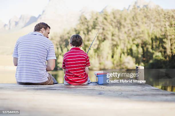 father fishing with son in lake - fishing tackle box stockfoto's en -beelden