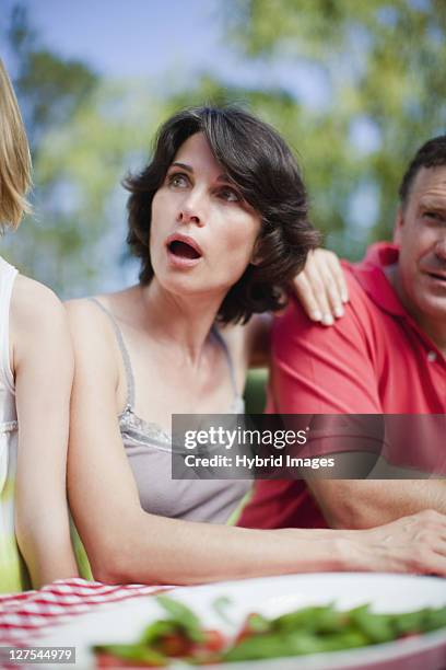 surprised woman sitting at picnic table - surprised mum stock pictures, royalty-free photos & images