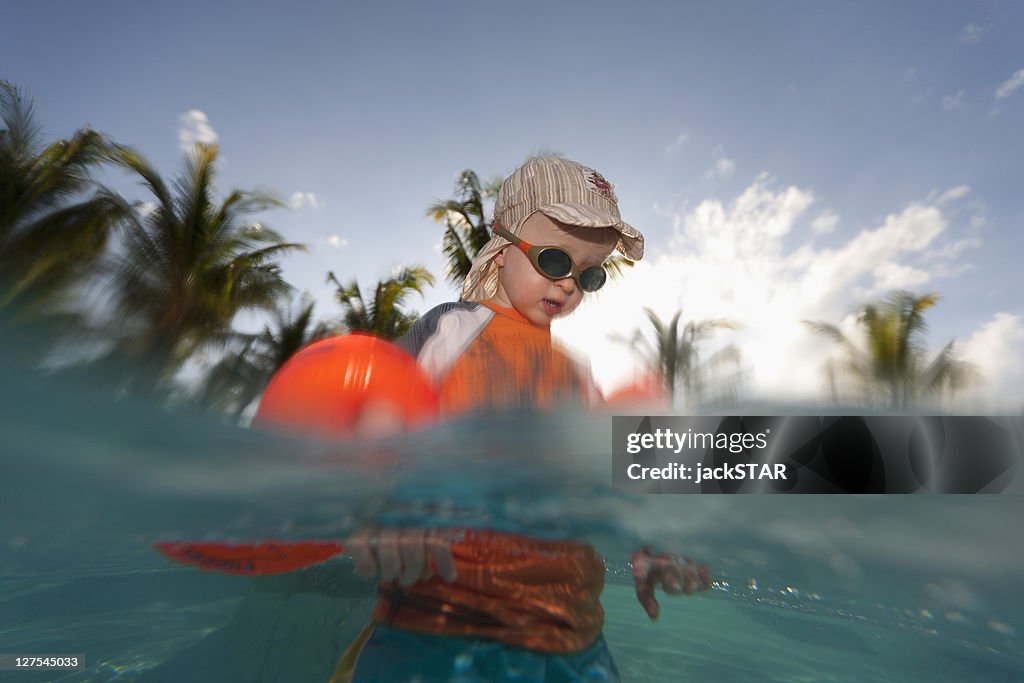 Toddler boy playing in water outdoors