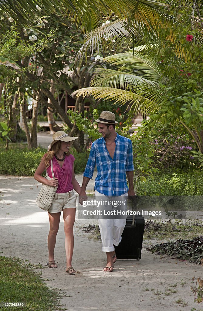 Couple walking hand-in-hand at resort