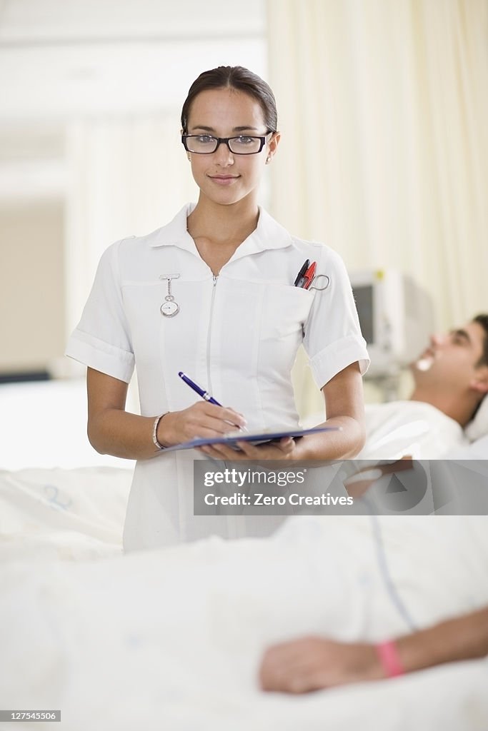 Nurse with clipboard in hospital room