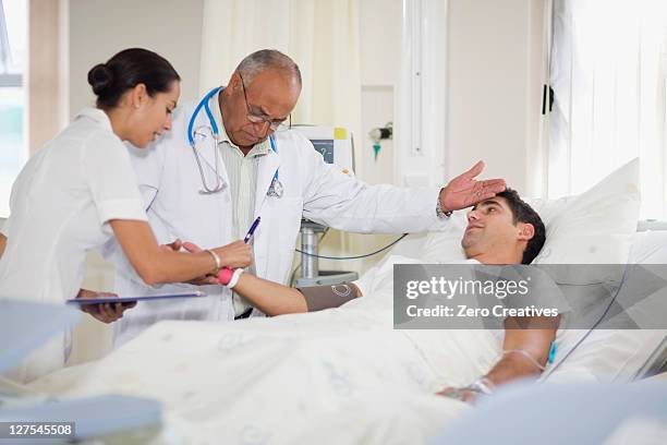 doctor and nurse with hospital patient - hospital identification bracelet stock pictures, royalty-free photos & images