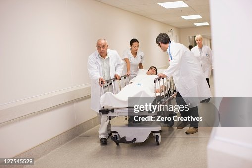 Patient Rushed Doctors Rushing Patient Down Hallway High-Res Stock Photo - Getty Images