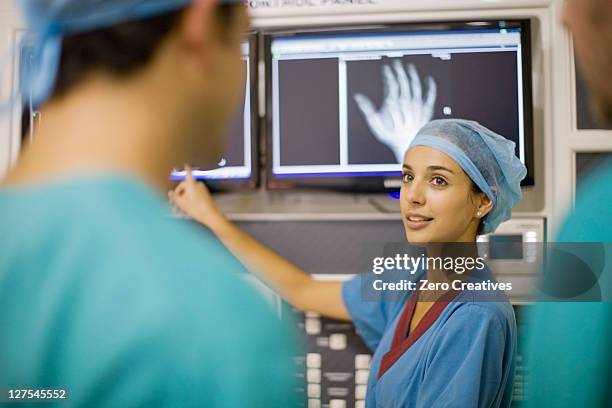 nurse examining x-ray of hand - radiologist 個照片及圖片檔