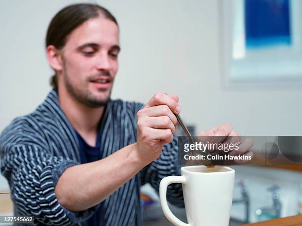 man making cup of tea in kitchen - tea bags stock pictures, royalty-free photos & images