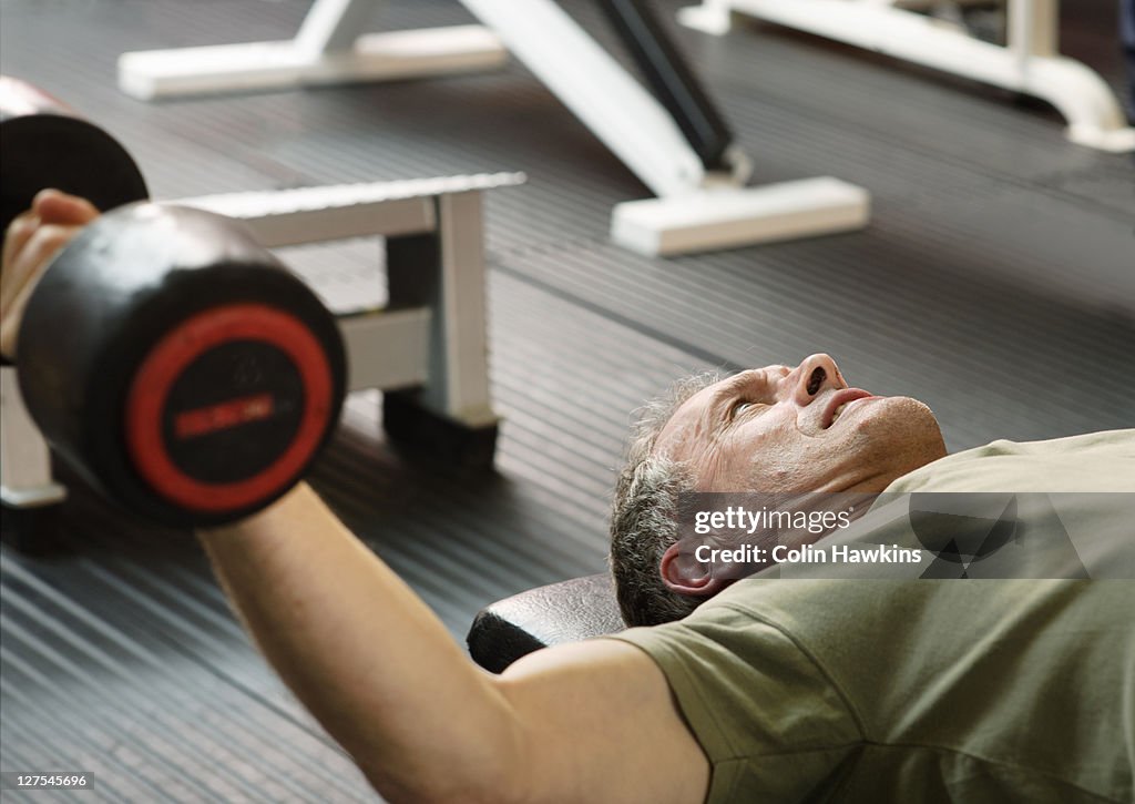 Man lifting weights at gym