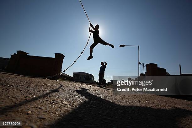Traveller youth plays on a rope at Dale Farm travellers camp on September 29, 2011 near Basildon, England. Traveller residents on the illegal Dale...