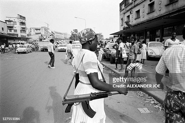 National Resistance Army young girl soldier poses with her kalashnikov, on January 1986 in Kampala. The children soldiers of the NRA are mostly...