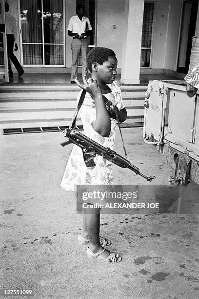 National Resistance Army girl soldier poses with her kalashnikov, 26 January 1986 in Kampala. The children soldiers of the NRA are mostly orphans...