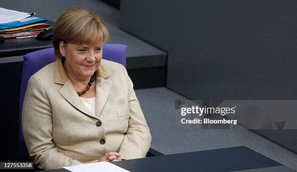 Angela Merkel, Germany's chancellor, reacts ahead of a vote to expanded the powers of the European Financial Stability Facility , in the lower-house...