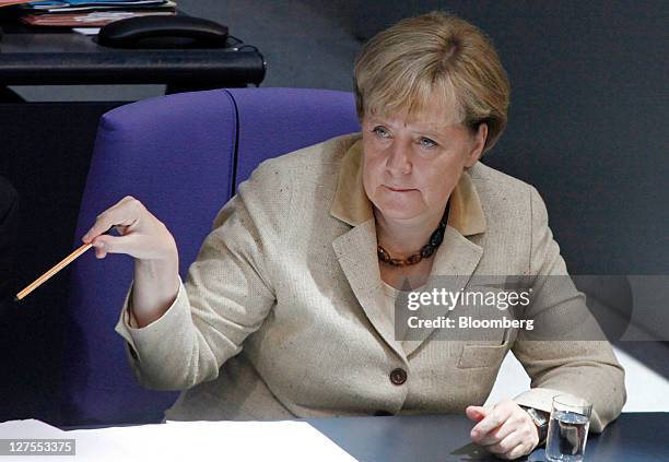 Angela Merkel, Germany's chancellor, gestures ahead of a vote to expanded the powers of the European Financial Stability Facility , in the...