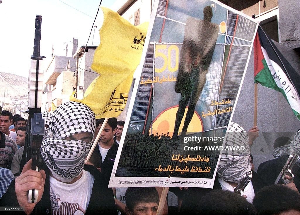 A masked Palestinian sports a Kalashniko