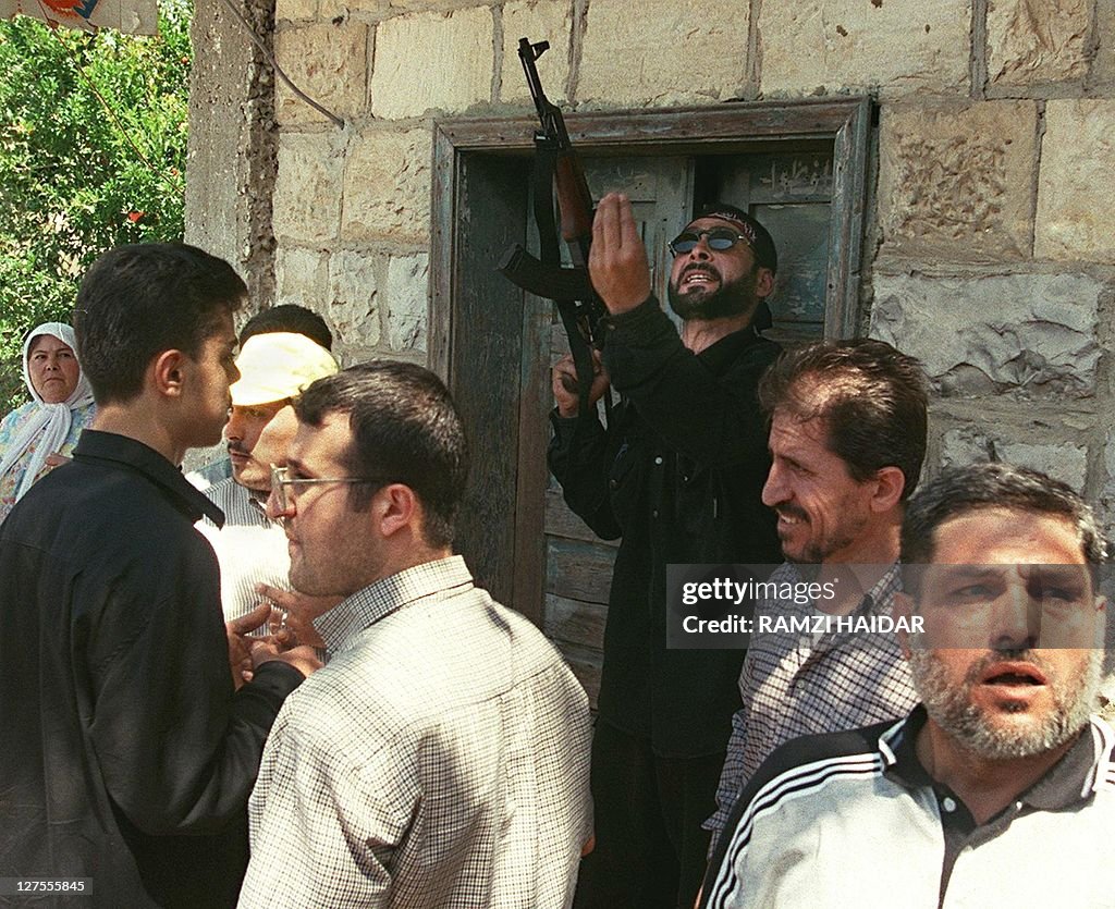 A Hezbollah fighter welding a Kalashniko
