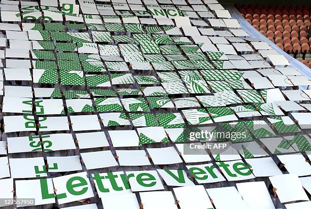 French La Poste employees present a giant 'human' stamp for the new "timbre vert" postage stamp on September 29, 2011 at the Parc des Princes stadium...