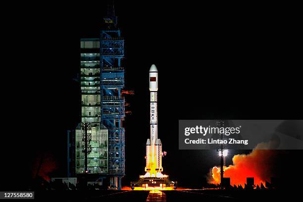 Long March 2F rocket carrying the country's first space laboratory module Tiangong-1 lifts off from the Jiuquan Satellite Launch Center on September...
