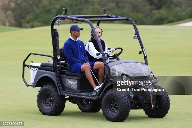 Tiger Woods of the United States speaks to TV personality David Feherty in an ATV across the bridge on the fifth hole during the Payne’s Valley Cup...