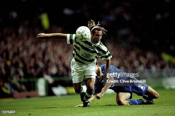 Henrik Larsson of Celtic and Sweden fends off a tackle during the qualifiying match between Celtic v Croatia Zagreb in a Champions League Cup played...