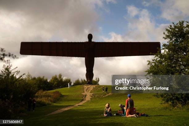 Family enjoy a picnic next to the Angel of the North on September 19, 2020 in Gateshead, United Kingdom. Since easing its first nationwide lockdown...