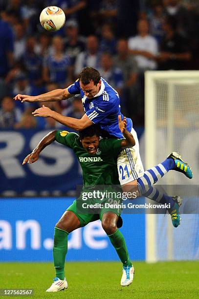 Marion de Jesus of Haifa is challenged by Christoph Metzelder of Schalke during the UEFA Europa League group J match between FC Schalke 04 and...