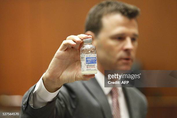 Deputy District Attorney David Walgren holds a bottle of propofol as he questions Alberto Alvarez, one of Michael Jackson's security guards, on the...