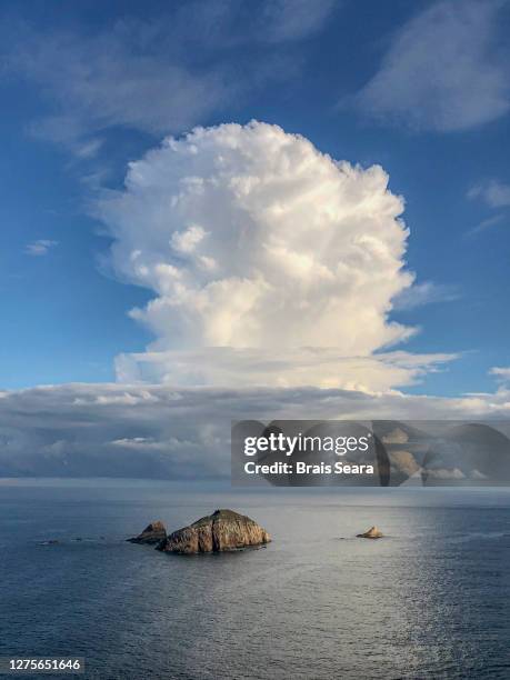 herbosa island under awesome cloud, asturias. - mushroom cloud stock pictures, royalty-free photos & images