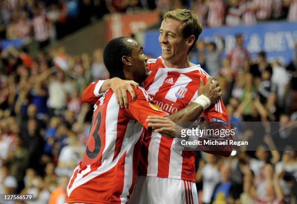 Peter Crouch of Stoke City celebrates scoring his team's first goal with team mate Cameron Jerome during the UEFA Europa League Group E match between...