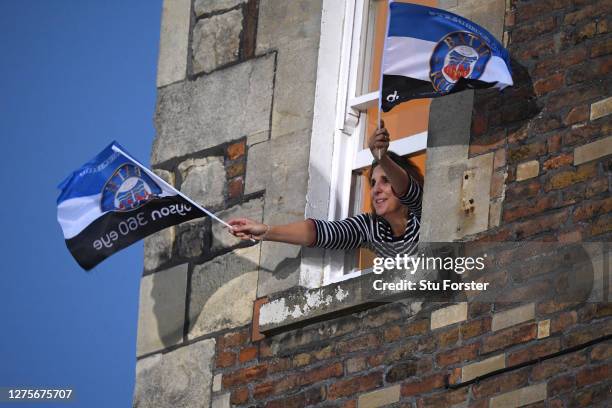 Lady supports Bath from her window at a house overlooking the pitch during the Gallagher Premiership Rugby match between Bath Rugby and Gloucester...