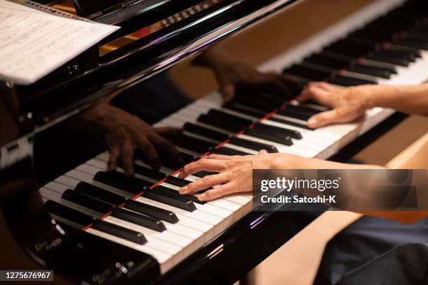 close up of pianist playing the piano at concert - piano concert stock pictures, royalty-free photos & images