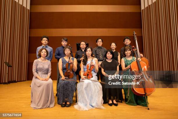 group shot of musicians at concert hall - classical musician stock pictures, royalty-free photos & images