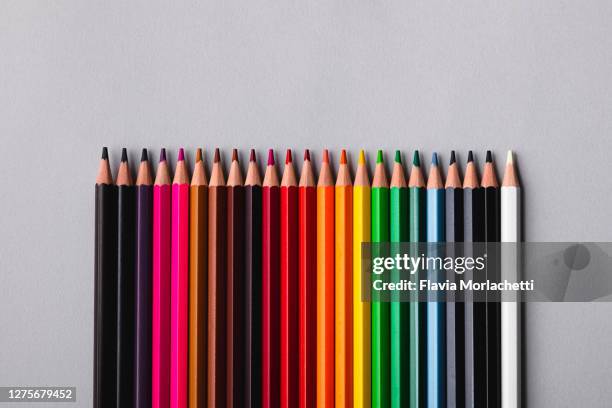 multi colored pencils in line - colored pencil flat lay stock pictures, royalty-free photos & images