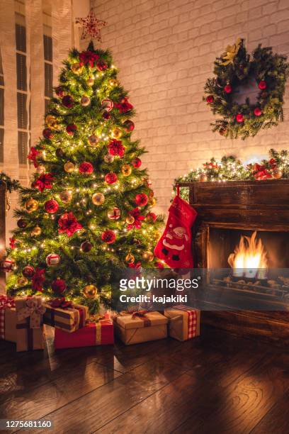 decorated christmas tree near fireplace at home - red stockings stock pictures, royalty-free photos & images