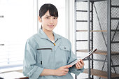 A Japanese female worker inspects a house's equipment