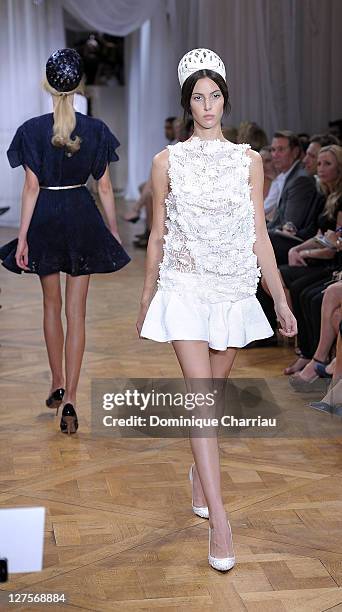 Model walks the runway during the Nina Ricci Ready to Wear Spring / Summer 2012 show during Paris Fashion Week on September 29, 2011 in Paris, France.