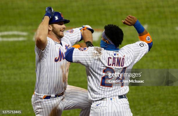 Pete Alonso of the New York Mets celebrates his fourth inning home run against the Tampa Bay Rays with teammate Robinson Cano at Citi Field on...