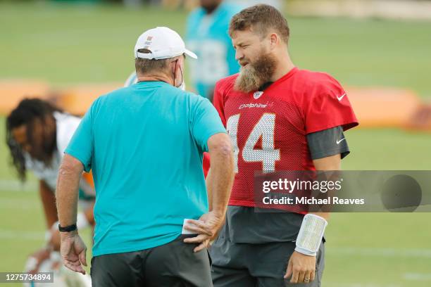 Ryan Fitzpatrick of the Miami Dolphins talks with offensive coordinator Chan Gailey during practice at Baptist Health Training Facility at Nova...