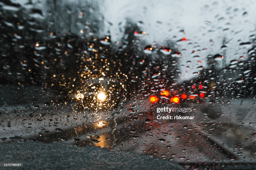 Blurred drizzle on the windshield in the evening