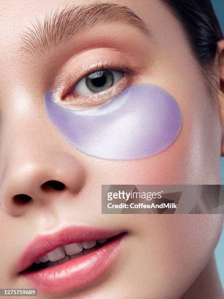 woman with eye patches under her eyes - textile patch stock pictures, royalty-free photos & images