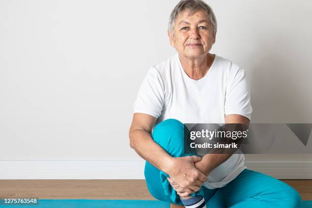 senior woman on sport mat - portrait solid stock pictures, royalty-free photos & images