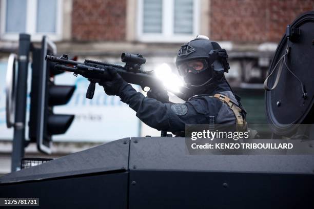 Police officer of unit RAID holds a position in an anti-riot vehicle during protests in Lille, northern France, on June 29 two days after a teenager...