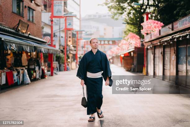 caucasian tourist exploring tokyo backstreets whilst wearing traditional japanese yukata - tourist ストックフォトと画像