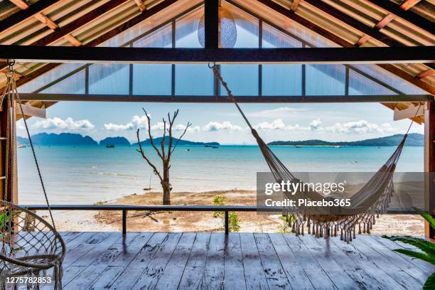 hammock in wooden bedroom balcony stilt house with ocean view - hut interior stock pictures, royalty-free photos & images