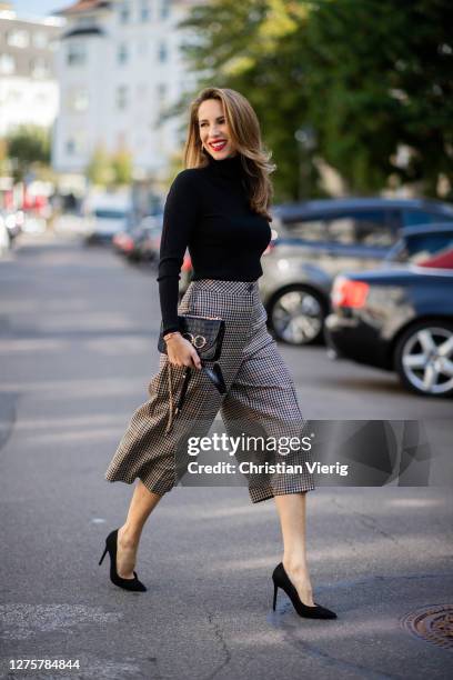 Alexandra Lapp is seen wearing Marc Cain cropped pants, black Marc Cain turtleneck, Marc Cain bag and heels on September 18, 2020 in Dusseldorf,...