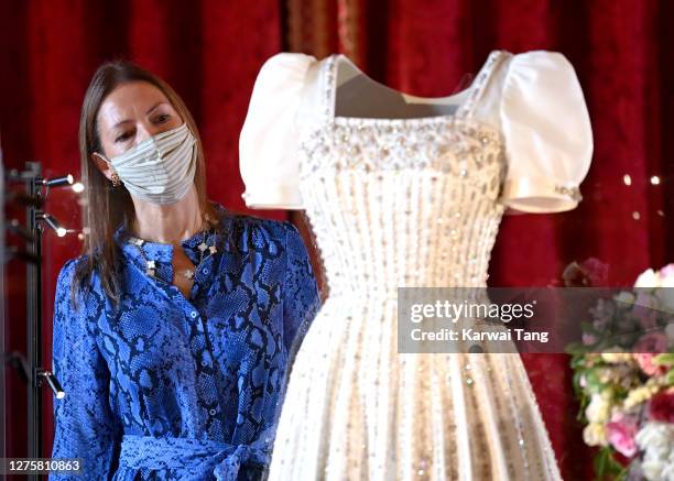 Royal Collection Trust Curator Caroline de Guitut views HRH Princess Beatrice of York's wedding dress on display at Windsor Castle on September 23,...